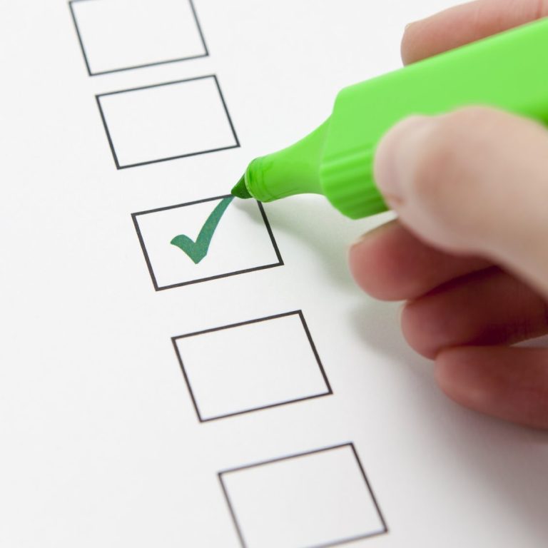 Green highlighter marking a checked box on a checklist.